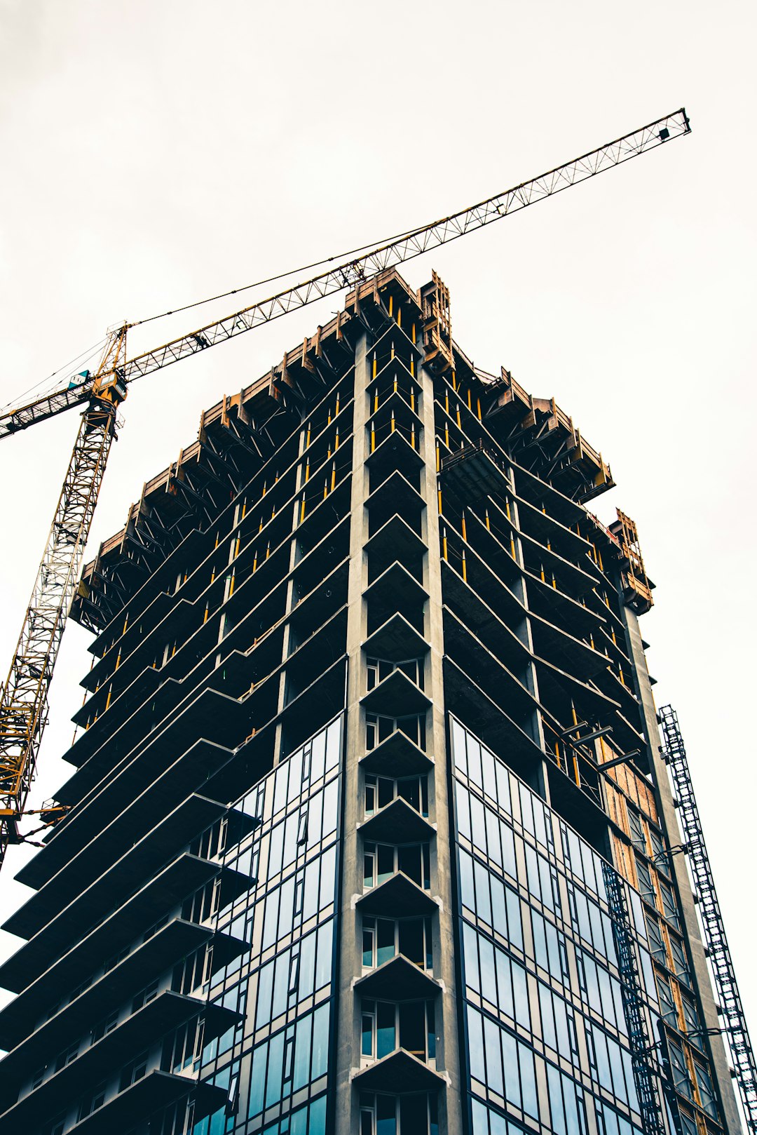 black-and-white-building-with-yellow-crane-d3vp0m7ot6c